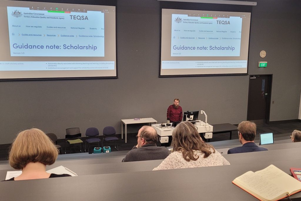 Keynote Speaker Associate Professor Michael Cowling presenting in the main auditorium.